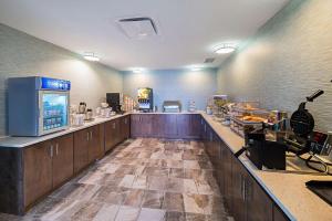 a large kitchen with a long counter in a room at Comfort Inn & Suites Oklahoma City near Bricktown in Oklahoma City