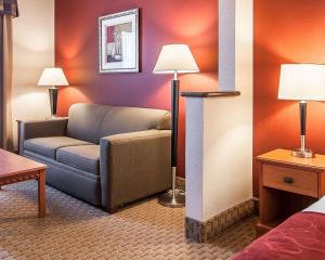 a living room with a couch, coffee table and a lamp at Comfort Suites Redmond Airport in Redmond