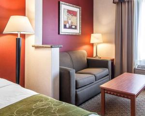 a living room with a couch and a coffee table at Comfort Suites Redmond Airport in Redmond