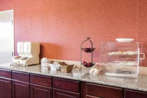 a kitchen with a counter with a counter top with a counter at Bridgeway Inn & Suites in Sublimity +10 photos