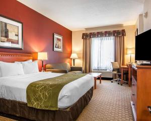 a hotel room with a bed and a television at Comfort Suites Redmond Airport in Redmond