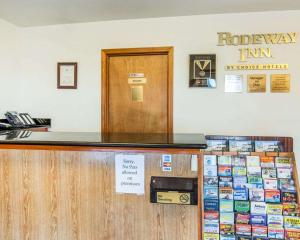 a cashier counter at a roelandeway inn with signs on it at Rodeway Inn in Newport