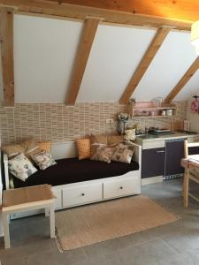a living room with a couch and a kitchen at Apartments Vjeverica in Zelin Mrzlovodički
