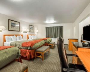 a hotel room with two beds and a flat screen tv at Rodeway Inn in Newport