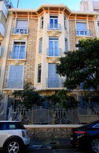 a white car parked in front of a building at Appartement Vaste Horizon - LRA Cannes in Cannes