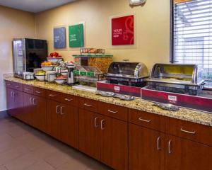 a kitchen with a counter with some food on it at Comfort Inn & Suites in Erie