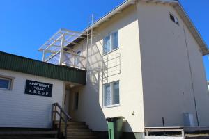 a white building with a sign on the side of it at VASA Apartments in Rovaniemi