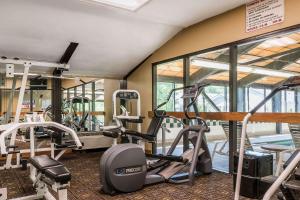 a gym with several treadmills and elliptical machines at Comfort Inn in Pine Grove