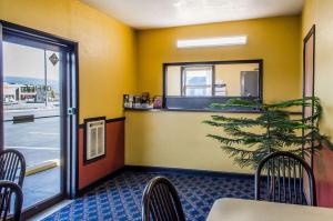 a restaurant with a table and chairs and a window at Relax Inn in Lewisburg