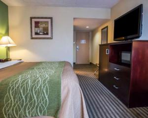 a hotel room with a bed and a flat screen tv at Quality Inn Mill Hall - Lamar in Clintondale +28 photos