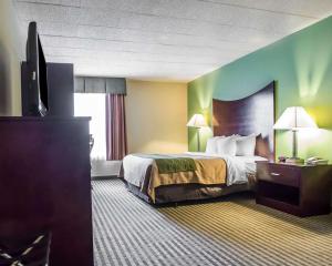 a hotel room with a bed and a flat screen tv at Quality Inn Mill Hall - Lamar in Clintondale