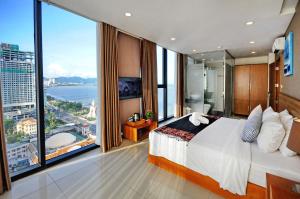 a bedroom with a large bed and a large window at Holi Beach Hotel & Apartments in Nha Trang +232 photos