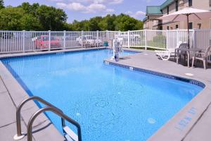a large blue swimming pool with a person standing next to it at Quality Inn Selinsgrove in Selinsgrove
