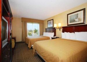 a hotel room with two beds and a television at Quality Inn & Suites Bensalem in Bensalem