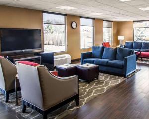 a waiting room with couches and a flat screen tv at Quality Inn & Suites NJ State Capital Area in Morrisville