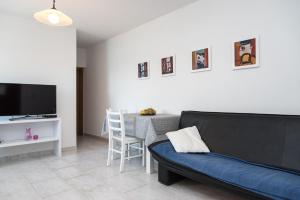 a living room with a couch and a table at Apartments Lavanda in Vinišće