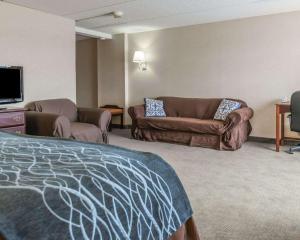a hotel room with a bed and a couch at Rodeway Inn in Mercer