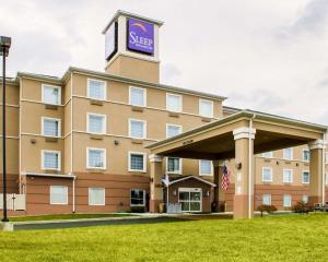 a hotel with a sign on top of it at Sleep Inn & Suites Harrisburg -Eisenhower Boulevard in Harrisburg