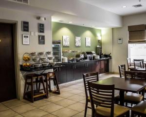 a restaurant with a counter and tables and chairs at Sleep Inn & Suites Harrisburg -Eisenhower Boulevard in Harrisburg