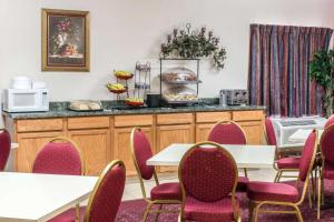 a conference room with tables and chairs and a counter at Econo Lodge Carlisle in Carlisle