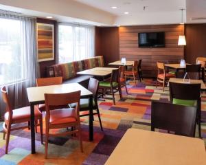 a restaurant with tables and chairs and a flat screen tv at Quality Inn Cranberry Township in Cranberry Township