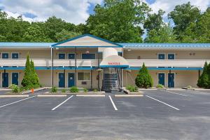 an empty parking lot in front of a motel at Rodeway Inn Milford - I-84 in Milford