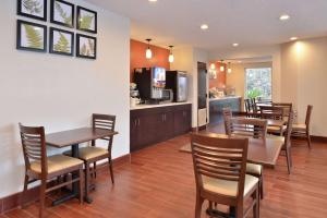 a restaurant with tables and chairs and a bar at Sleep Inn Beaufort near MCAS in Beaufort