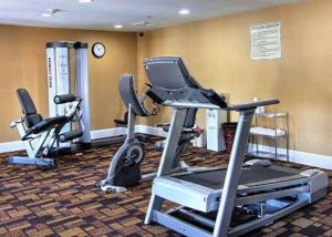 a gym with two exercise bikes and a treadmill at Quality Inn & Suites Greenville near downtown in Greenville