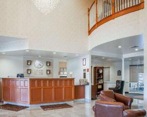a large lobby with a waiting area and a staircase at Comfort Suites West Warwick - Providence in West Warwick