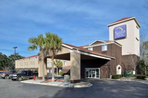 a store front of a hotel with a palm tree at Sleep Inn Beaufort in Beaufort