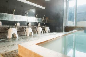 a bathroom with a row of sinks and mirrors at Emblem Flow Hakone in Hakone