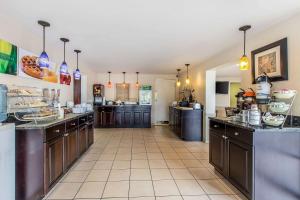 a large kitchen with brown cabinets and a counter top at Quality Inn Easley in Easley