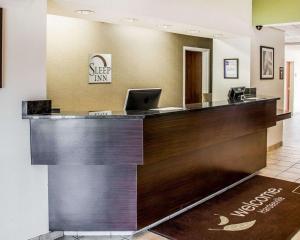 a hotel lobby with a reception desk with a laptop at Sleep Inn Hardeeville in Hardeeville