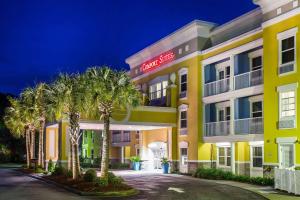 a hotel with palm trees in front of it at Comfort Suites at Isle of Palms Connector in Charleston