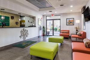 a lobby of a waiting room with yellow and orange chairs at Quality Inn & Suites Greenville - Haywood Mall in Greenville