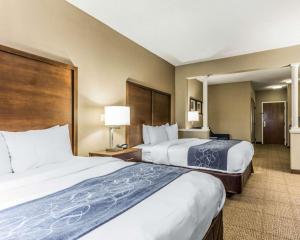 a hotel room with two beds and two lamps at Comfort Suites at Isle of Palms Connector in Charleston +31 photos