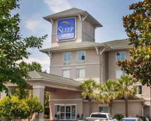 a building with a sign on top of it at Sleep Inn North Charleston Ashley Phosphate in Charleston