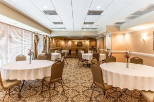 uma sala de banquetes com mesas e cadeiras brancas em Quality Inn & Suites Georgetown em Georgetown