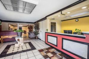 a lobby with a waiting area with a table in it at Rodeway Inn Expo Center in Spartanburg