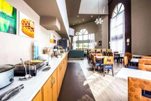 a kitchen with a counter and a dining room at Quality Inn at the Park in Fort Mill