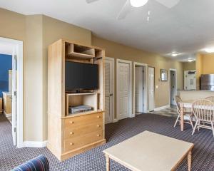 a living room with a flat screen tv and a table at Bluegreen Vacations Harbour Lights in Myrtle Beach