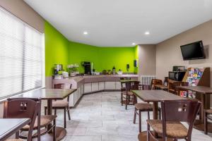 a restaurant with tables and a green wall at classic inn in Memphis