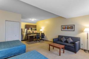 a room with a bed and a couch and a kitchen at MainStay Suites Brentwood-Nashville in Brentwood
