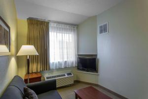 a living room with a couch and a television at MainStay Suites Brentwood-Nashville in Brentwood