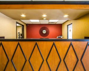 a bar at a hospital with a red wall at Rodeway Inn & Suites in Clarksville