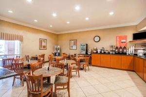 a restaurant with tables and chairs and a counter at Quality Inn & Suites Germantown North in Memphis