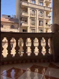 a balcony with a building in the background at Cozy new 2 BD Amazing beach view Next to Hilton hotel Family only !العائلات فقط in Alexandria