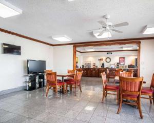 - une salle à manger avec une table, des chaises et une télévision dans l'établissement Econo Lodge, à Dyersburg