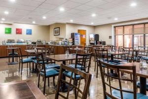 a dining room with wooden tables and chairs at Comfort Inn & Suites Airport-American Way in Memphis