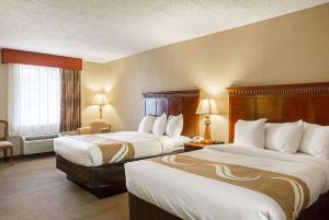 a hotel room with two beds and a window at Quality Inn Hurricane Mills I-40 in Hurricane Mills +13 photos